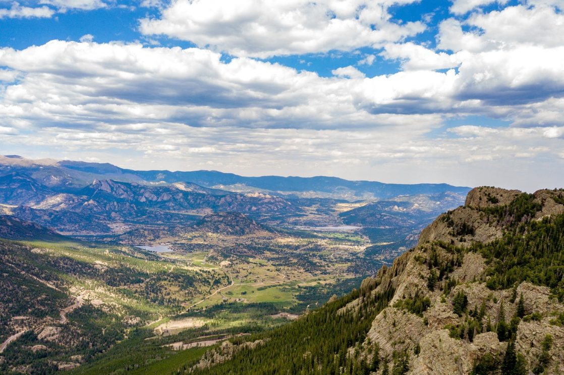 A photograph of the mountainous landscape around the camp.