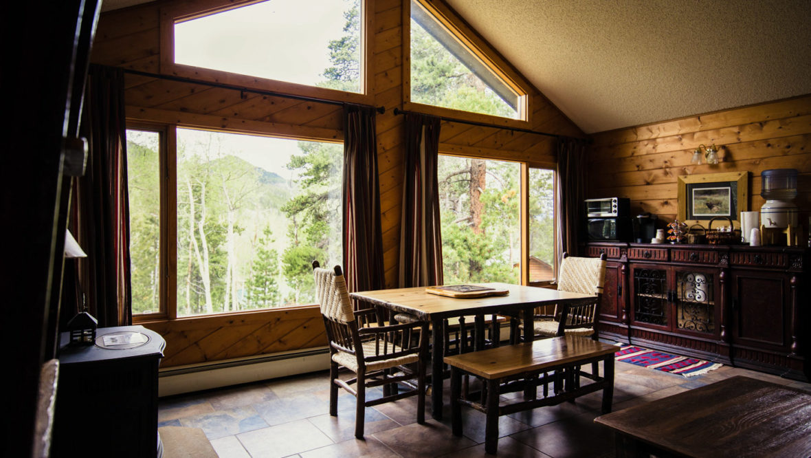 Chalet living room with large window and view.