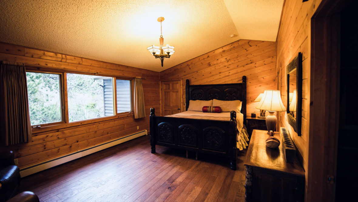 Chalet master bedroom with window.