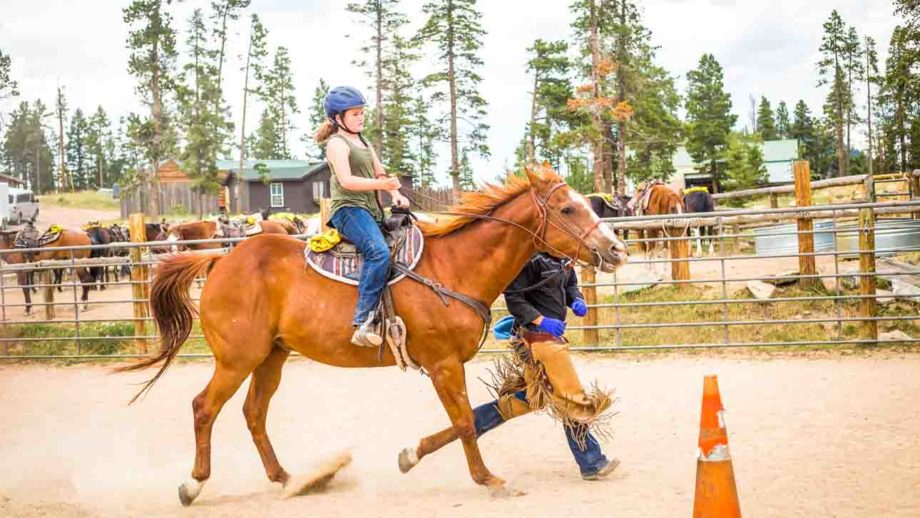 Little girl horse back riding