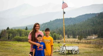 Family posing in front of the american flag