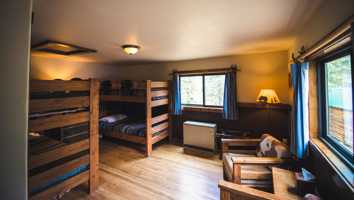 High meadow cabin kids room with two sets of bunkbeds.