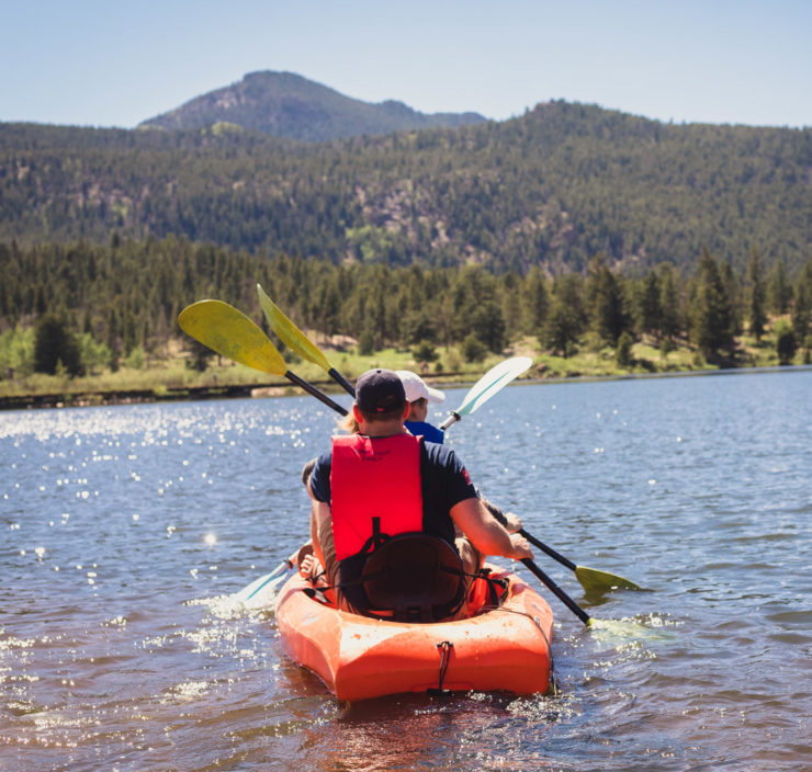 A couple kayaking on a lake together.