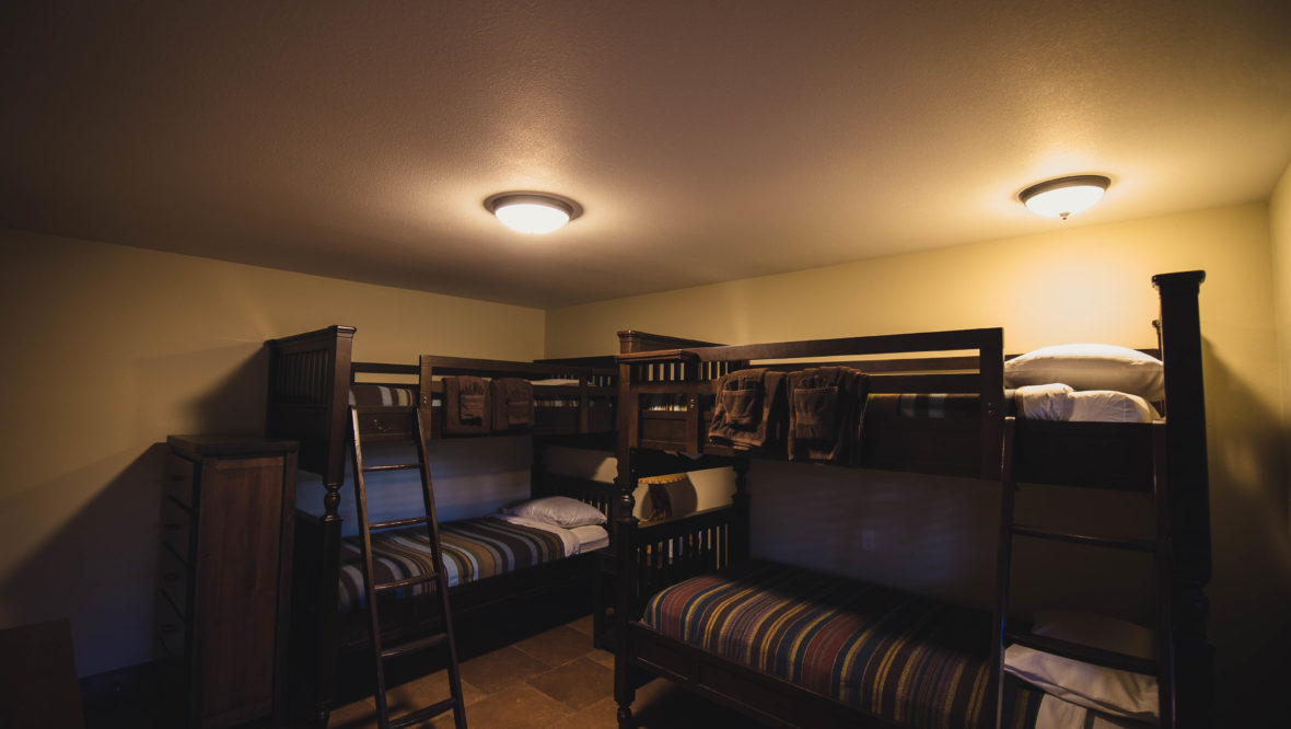 Spruce cabin downstars bedroom with two sets of bunkbeds