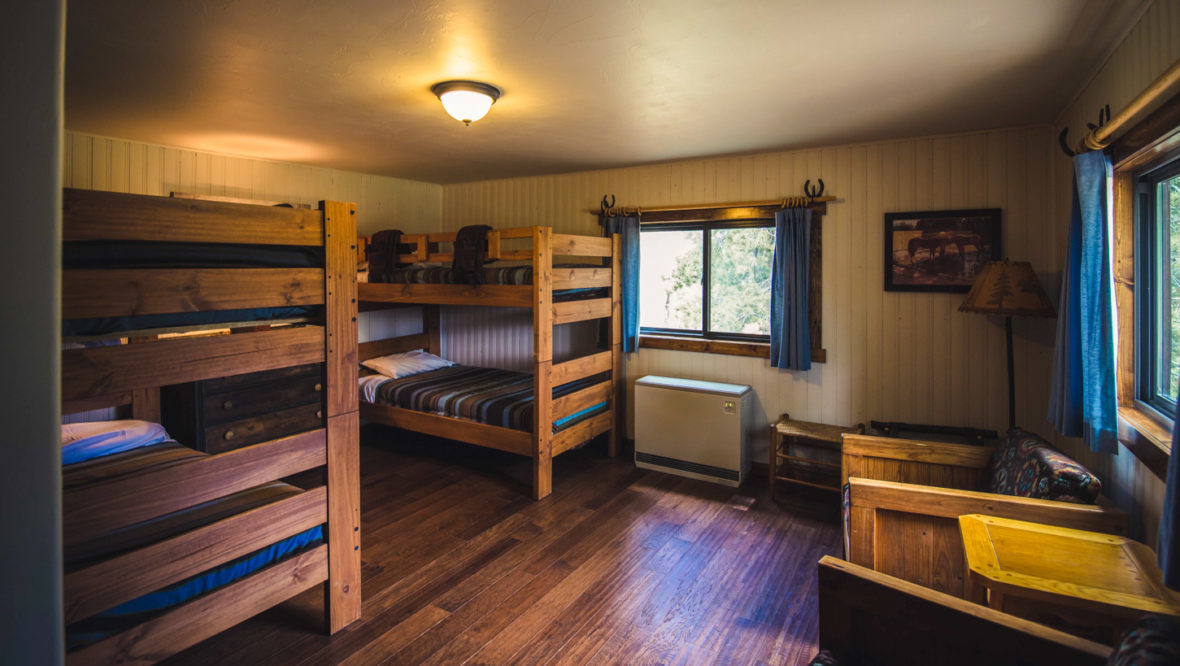 Aspen leaf cabin kid's bedroom with two sets of bunkbeds.