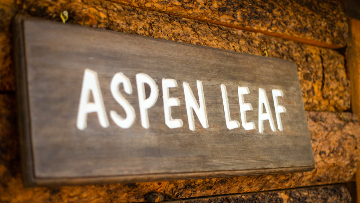 Aspen leaf cabin front porch with aspen leaf sign.