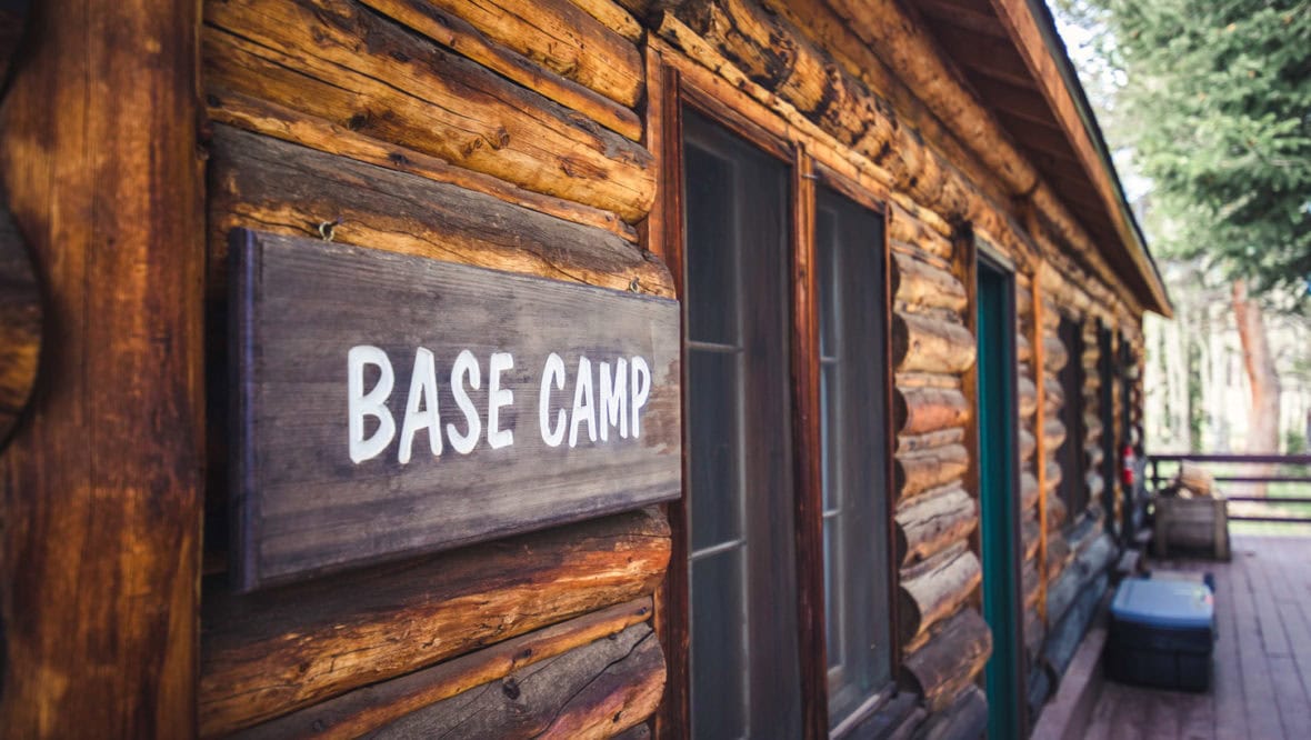 Basecamp C/D cabin front porch with a sign that says "Basecamp"