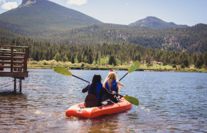 Two girl kayaking in a lake.