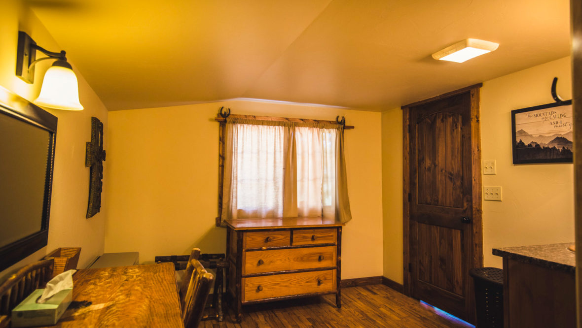 Long's peak cabin room with dresser and vanity.